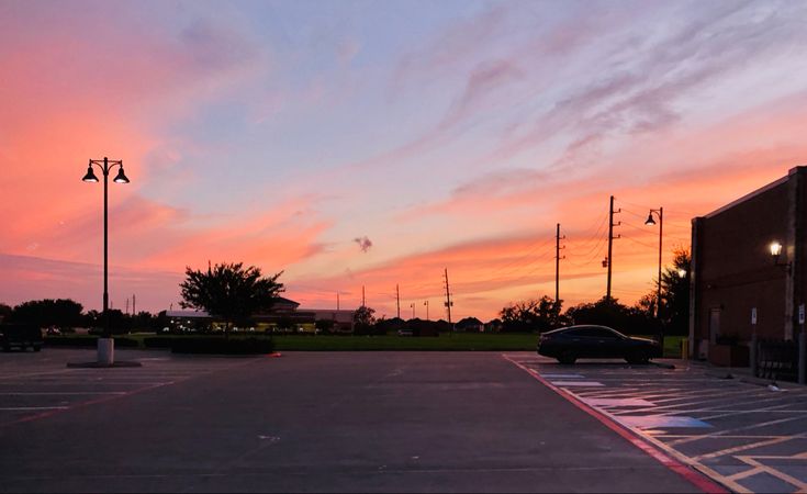 Mostly empty parking lot during the sunrise